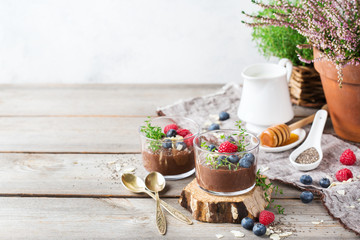 Healthy vegan chocolate chia pudding with berries and green thyme