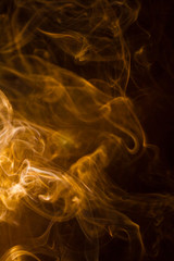 Gold smoke on black background.