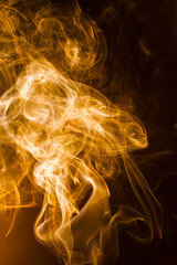 Gold smoke on black background.