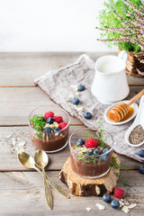 Healthy vegan chocolate chia pudding with berries and green thyme