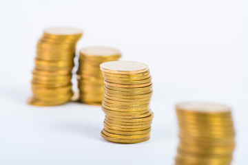 Columns of gold coins, piles of coins on white background