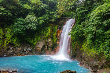Fototapeta na wymiar Celestial blue waterfall and pond in tenorio national park, Costa Rica
