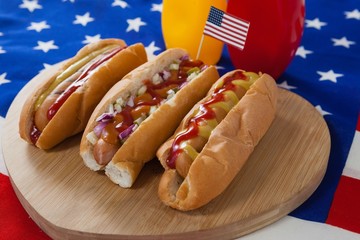 Hot dog and American flag on white wooden table