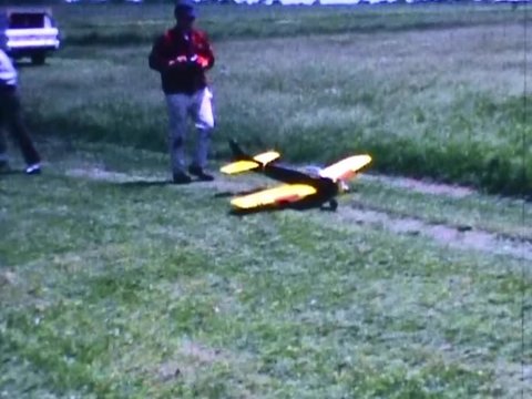 Radio controlled airplane pilot taxis his plane down grassy runway prior to flight at the Bridgewater state farm correctional institution in Fall 1967