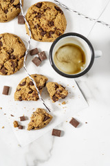 Cookies with dark chocolate chips on white plate.