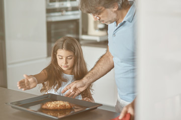 Nice daughter cooking with her father