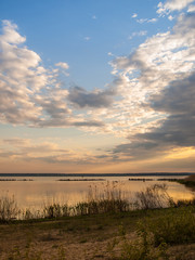 Obraz premium Picturesque view of the river at sunset with cloudy sky