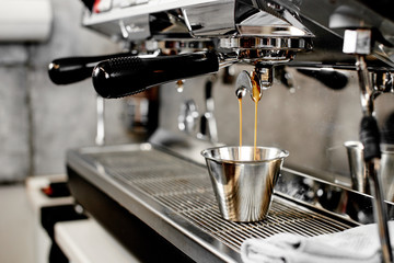 Barista. Mug standing in the coffee-making machine