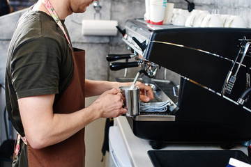Barista. Hand making the coffee closeup