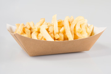 cardboard box of French fries in a takeaway dish of a snack