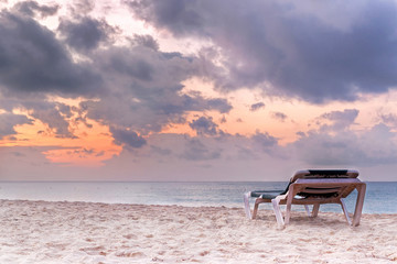 Deckchair on the Caribbean Sea at sunrise