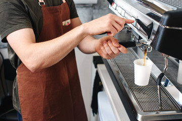 Fototapeta na wymiar Barista. Hand making the coffee closeup