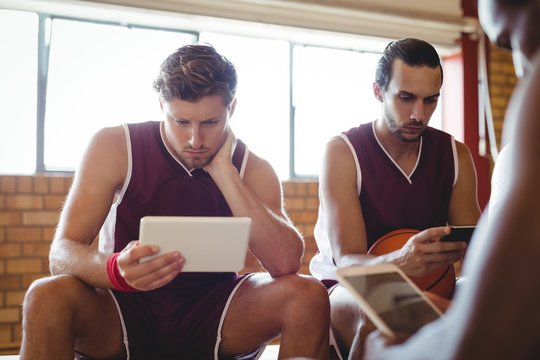 Basketball players using digital tablet