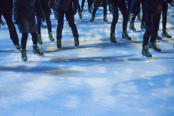 Obraz premium People ice skating. cropped image showing peoples legs