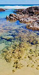  the beach near the rocks in the wave of ocean