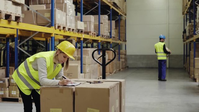 Young workers with tablet in a warehouse.