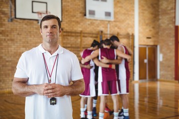 Confident coach standing in basketball court - Powered by Adobe