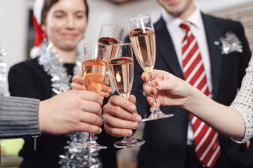 Hands holding the glasses of champagne making a toast in the off