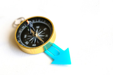 Miniature people : business man  on compass with color arrow