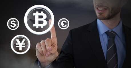 Businessman touching bitcoin graphic icon with currencies