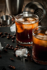 Alcohol. Drinks, Boozy Black Russian cocktail with vodka and coffee liquor on rustic wooden table. copy space