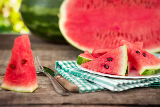 Watermelon slice with plate on cloth