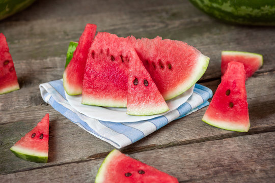 Slices of watermelon on plate and table