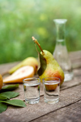 Shot glass with pear brandy and pear