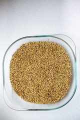 Seeds of dill in a glass cup.