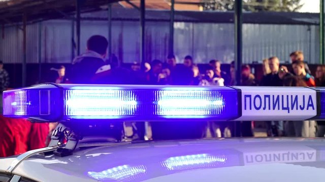 Blue Emergency Lights of Police Car ; Blinking blue lights on a police car at the scene of a traffic accident.Cyrillic inscription