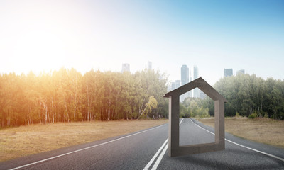 Conceptual background image of concrete home sign on asphalt road