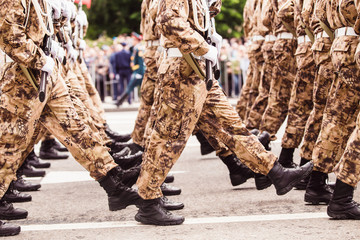 Soldiers in the form of khaki march in formation.