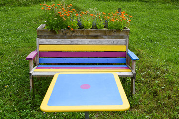 Multicolored bench and table in a garden of Engelberg