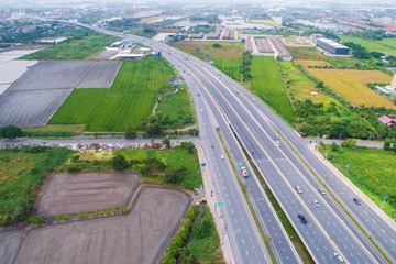 Motorway traffic junction road surrounded by green tree - obrazy, fototapety, plakaty