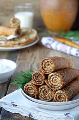 Russian pancakes with dill wrapped in rolls