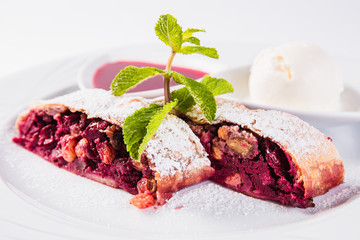 strudel  with jam and ice cream cold on a white plate on a light background (close up)