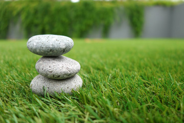 Pebbles stacked up on grass