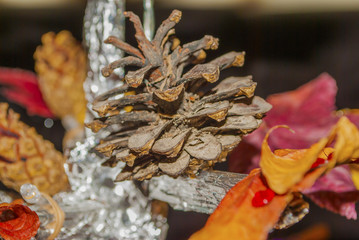 Dry pine cone and multi color leaves christmas tree natural decoration closeup. Christmas tree natural decorations can be used as background picture or greeting cards.