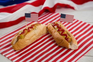 American flag and hot dogs on wooden table