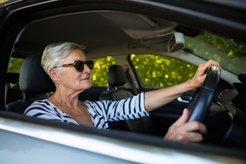Senior woman driving car