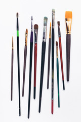 close-up view of various professional paint brushes isolated on white