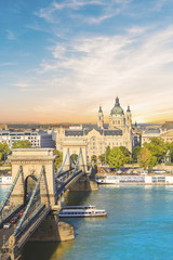 Fototapeta na wymiar Beautiful view of the Basilica of Saint Istvan and the Szechenyi chain bridge across the Danube in Budapest, Hungary