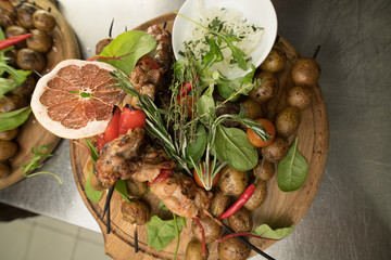 Delicious barbecued ribs seasoned with a spicy basting sauce and served with chopped fresh...