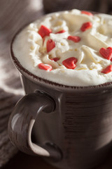 cup of coffee with whipped cream and red hearts