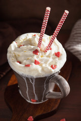 cup of coffee with whipped cream and red hearts