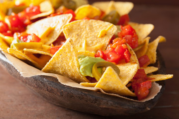 nachos loaded with salsa, guacamole, cheese and jalapeno