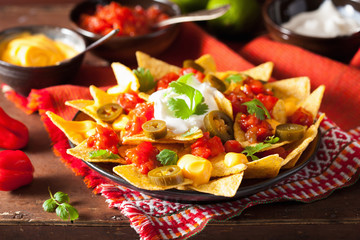 nachos loaded with salsa, cheese and jalapeno