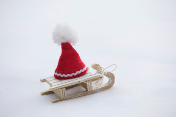 Santa Claus hat on a wooden made sleigh.