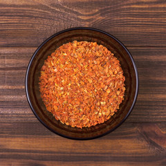 Dry carrot in a bowl on a wooden background
