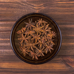 Anise spice in a bowl on a wooden background